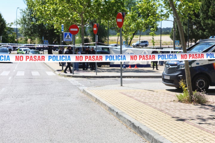 Police cordoned off a crime scene in a parking lot around 150 meters (500 feet) outside the gate of the American School of Madrid. 