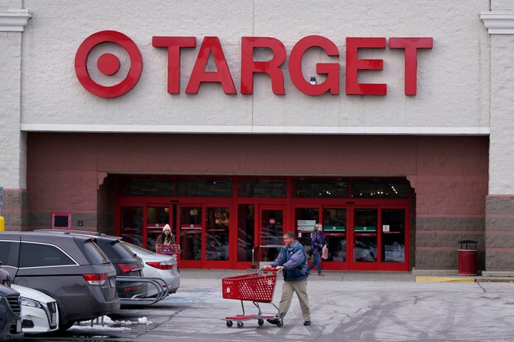 A shopper wheels a cart through the parking lot after making a purchase at the Target store, Monday, Feb. 27, 2023, in Salem, N.H. (AP Photo/Charles Krupa, File)
