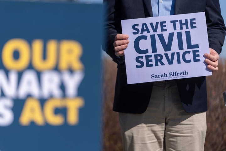 Gun Silencers, Tanning Beds And Different Bizarre Stuff Tucked Into The GOP's Tax Invoice 9 A fired federal probationary worker holds a sign reading "Save the Civil Service" at a news conference about the Protect Our Probationary Employees Act on March 11, 2025, in Washington.