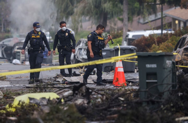 Investigators look through the site where a small plane crashed into a San Diego, California, residential street on May 22, 2025. (Photo by Sandy Huffaker / AFP via Getty Images)
