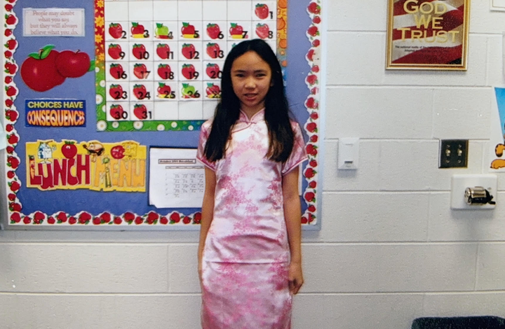 "This is me in fifth grade (2005) 'dressed up as' a Chinese person for a school project (I would also wear this as a 'costume' for Halloween that year)," the author writes. "Peep the 'In God We Trust' frame in the background."