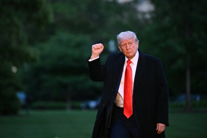 President Donald Trump pumps his fist upon arrival at the South Lawn of the White House in Washington, DC, on May 22, 2025. (Photo by Mandel NGAN / AFP via Getty Images)