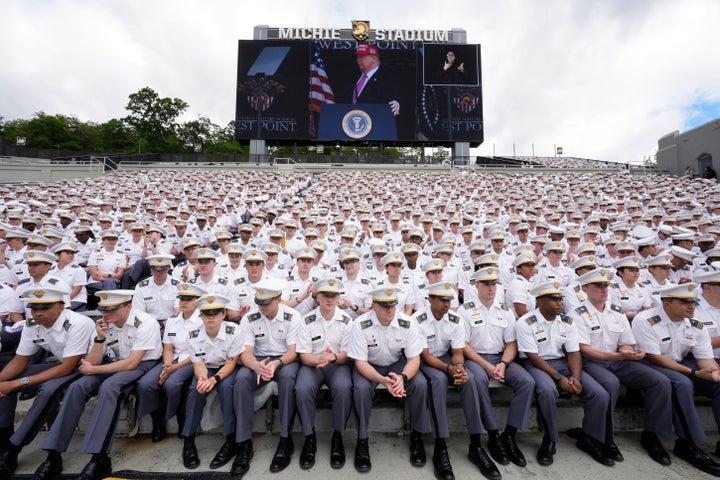 Cadets listen as President Donald Trump, seen on screen, speaks to United States Military Academy graduating cadets during commencement ceremonies in West Point, N.Y., Saturday, May 24, 2025. (AP Photo/Manuel Balce Ceneta)