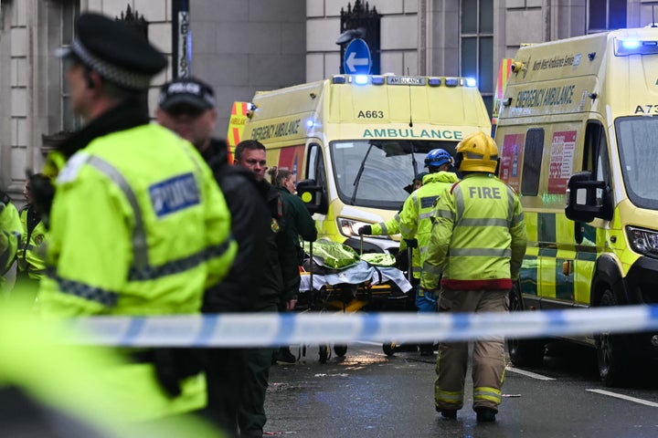 A person is evacuated on a stretcher as police and ambulance gather on the scene of an incident in Water Street, on the sidelines of an open-top bus victory parade for Liverpool's Premier League title win, in Liverpool, north-west England on May 26, 2025.