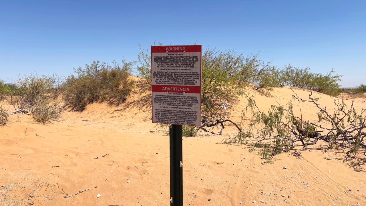 A Defense Department sign warning "unauthorized entry is prohibited," about 50 feet north of the U.S.-Mexico border.
