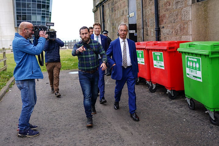 Nigel Farage and deputy Reform leader Richard Tice leave the venue following the press conference.