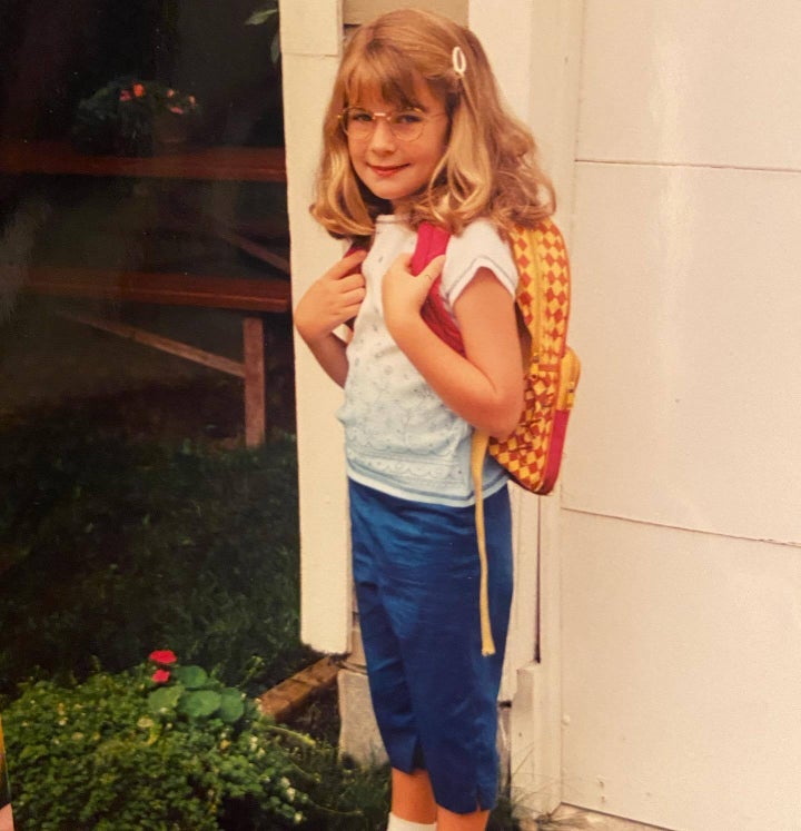 The author poses for an obligatory first day of school photo, wearing a pair of fake glasses that she believed to be VERY cool.