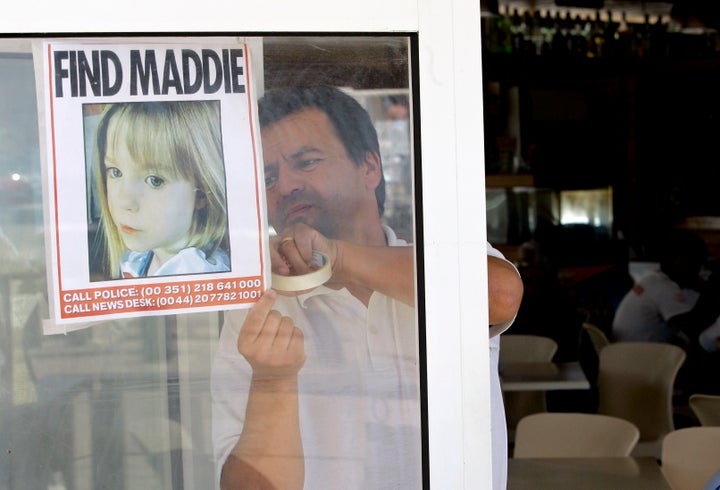 A waiter displays a picture of the missing toddler in southern Portugal in 2007. 