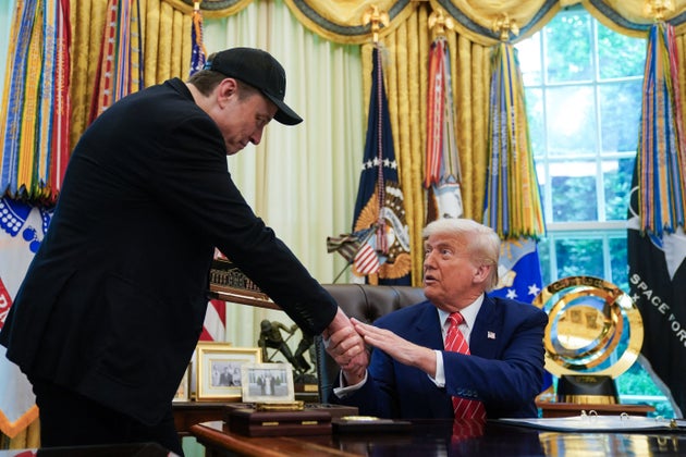 US President Donald Trump shakes hands with Elon Musk