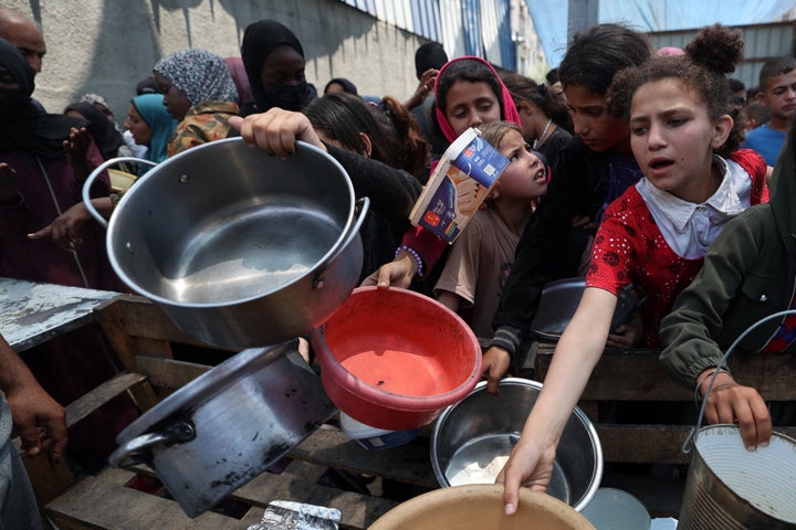 Palestinian children gather at a hot meal distribution point in Nuseirat in the central Gaza Strip, June 4, 2025. The U.S. and Israeli-backed Gaza Humanitarian Foundation group operating aid sites in the Gaza Strip announced the temporary closure of the facilities on June 4 following a string of deadly incidents near the distribution sites it operates that have sparked condemnation from the United Nations. 