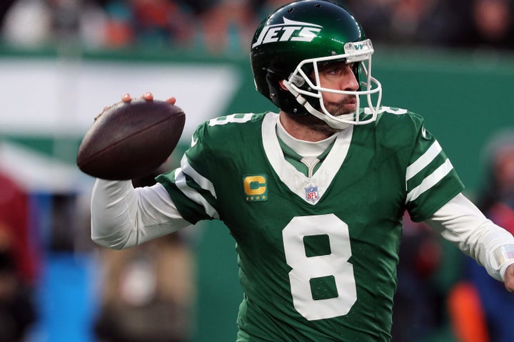 EAST RUTHERFORD, NEW JERSEY - JANUARY 5: Quarterback Aaron Rodgers #8 of the New York Jets rolls out to pass the ball in the game between the Miami Dolphins against the New York Jets at MetLife Stadium on January 5, 2025 in East Rutherford, New Jersey. (Photo by Al Pereira/Getty Images)