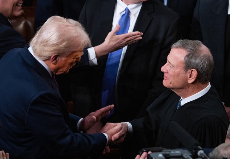 President Donald Trump greets Chief Justice John Roberts before Trump delivered his address to a joint session of Congress in the House Chamber of the U.S. Capitol on Tuesday, March 4, 2025.