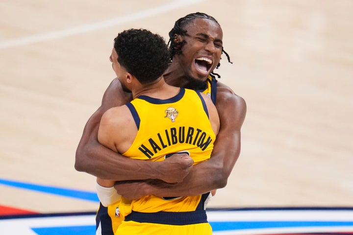 Indiana Pacers guard Tyrese Haliburton (0) celebrates with forward Aaron Nesmith (23) after making a 3-pointer during the second half of Game 1 of the NBA Finals basketball series against the Oklahoma City Thunder Thursday, June 5, 2025, in Oklahoma City. (AP Photo/Julio Cortez)