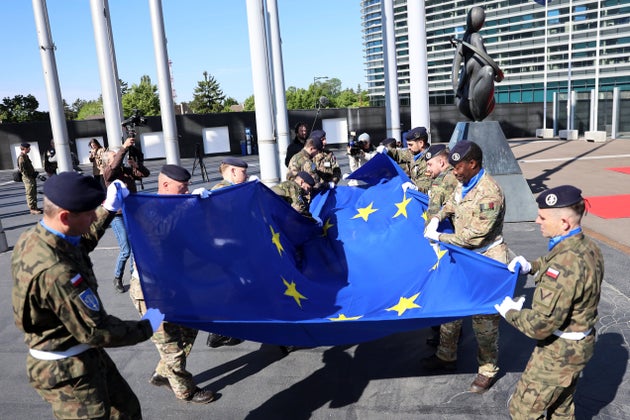 Eurocorps soldiers unfold the European flag during a ceremony marking the 80th anniversary of the end of WWII in Europe, Wednesday, May 7, 2025 at the European Parliament in Strasbourg, eastern France. (AP Photo/Antonin Utz)