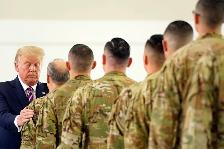 After being briefed on wildfires, President Donald Trump participates in a ceremony recognizing the California National Guard at Sacramento McClellan Airport, in McClellan Park, California, on Sept. 14, 2020.
