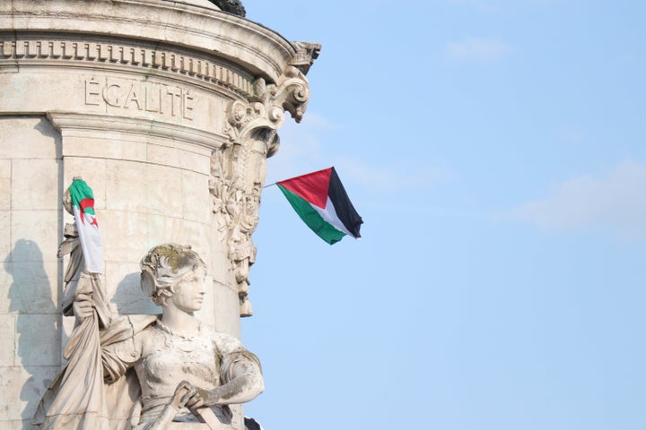 Israel Attracts Outrage For Seizing Gaza-Certain Support Boat And Detaining Activists 1 Protesters raise Palestinian flags at Place de la Republique in Paris, on June 9, calling for the release of the passengers of the sailing boat Madleen, intercepted in international waters by the Israeli army.
