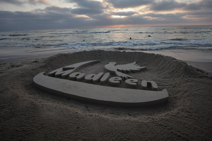 A sand sculpture reading 'Madleen' is drawn by Palestinian artist Yazeed Abu Jarad on the coast of Gaza City in support of the aid ship carrying 12 human rights activists, in Gaza on June 9. The Madleen is expected to be brought to Ashdod Port after Israeli forces intercepted it and detained the activists on board.