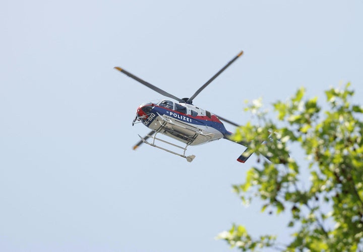 A police helicopter is seen in the air close to a school where, according to reports, several people died in a shooting, on June 10, 2025 in Graz, southeastern Austria.
