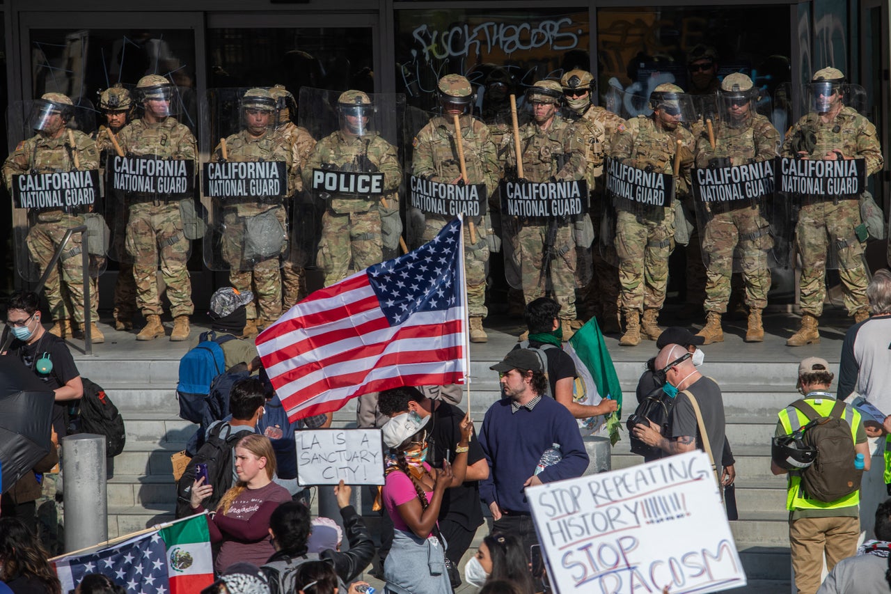 Demonstrators face California National Guard members standing guard outside the Federal Building as they protest in response to federal immigration operations in Los Angeles.