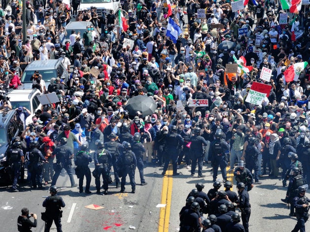 Hundreds of protesters gather to demand an immediate end to Immigration and Customs Enforcement (ICE) workplace raids in Los Angeles on June 8.