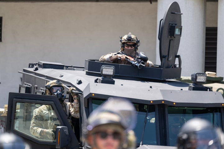 Federal law enforcement and National Guardsmen stand ready during a protest outside the Federal Metropolitan Detention Center in Los Angeles on Tuesday, June 10, 2025.