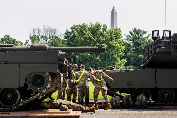 Members of the military work on an Abrams tank at West Potomac Park ahead of the U.S. Army's 250th anniversary parade in Washington, D.C.