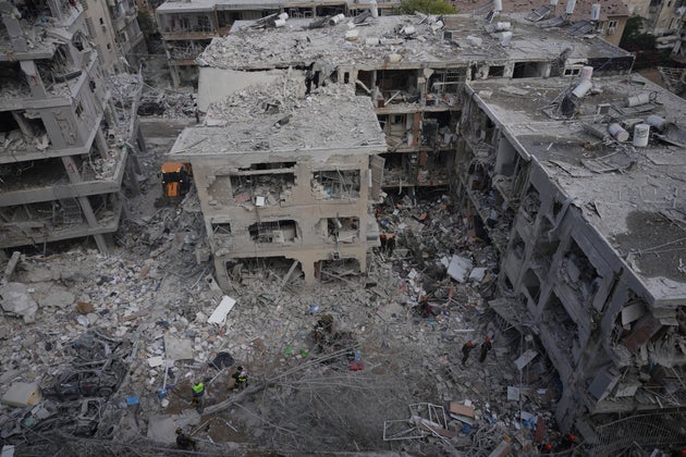 Israeli first responders work in a residential area hit by a missile fired from Iran, near Tel Aviv, Israel, Sunday, June 15, 2025.(AP Photo/Ariel Schalit)