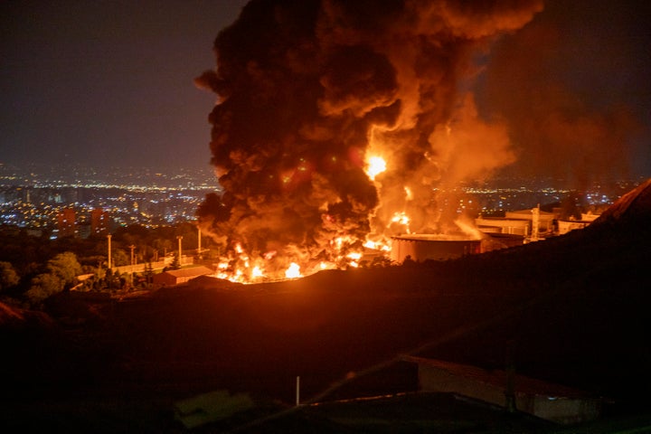 TEHRAN, IRAN - JUNE 15: Fire and smoke rise into the sky after an Israeli attack on the Shahran oil depot on June 15, 2025 in Tehran, Iran. Iran's foreign minister said the country would respond decisively and proportionally to a wave of attacks that Israel launched beginning in the early hours of June 13. The attacks targeted multiple military, scientific and residential locations, as well as senior government officials. (Photo by Stringer/Getty Images)