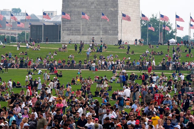 People on the lawn around the Washington Monument as President Donald Trump attends a military parade commemorating the Army's 250th anniversary, coinciding with his 79th birthday, Saturday, June 14, 2025, in Washington. 