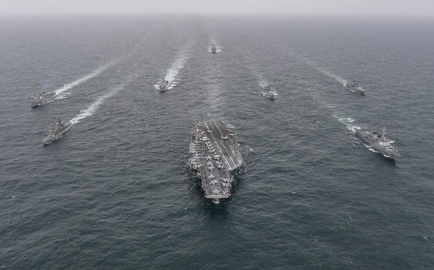 FILE - In this photo provided by the South Korea Defense Ministry, South Korean Navy's destroyer Yulgok Yi I, front row right, U.S. Navy's aircraft carrier USS Nimitz, center, Japan Maritime Self-Defense Force's Umigiri, front row left, sail in formation during a joint naval exercise in international waters off South Korea's southern island of Jeju on April 4, 2023. (South Korea Defense Ministry via AP, File)