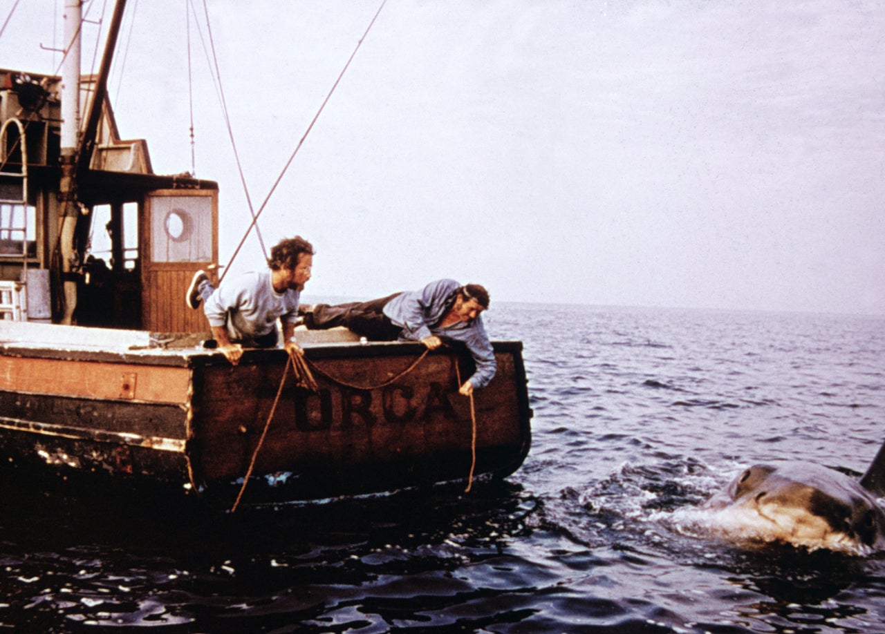 Richard Dreyfuss (L) and Robert Shaw hold ropes while leaning off the back of their boat, Orca, in pursuit of the giant great white shark in "Jaws."