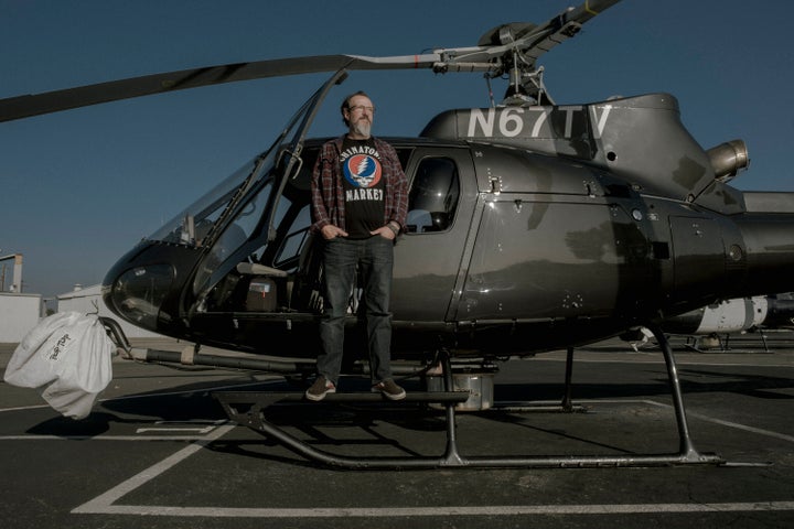 Stu Mundel, a Los Angeles TV helicopter reporter for Fox 11, poses for a portrait inside one of the helicopters in 2021.