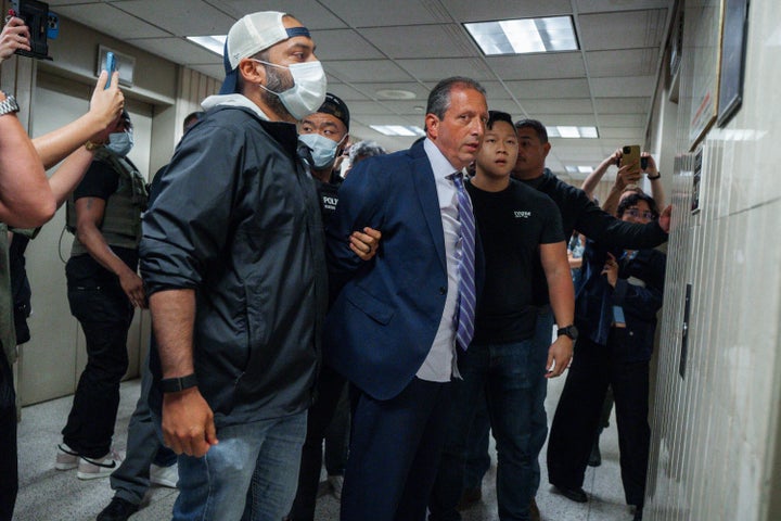 Lander asked to see a judicial warrant as federal agents led him away.