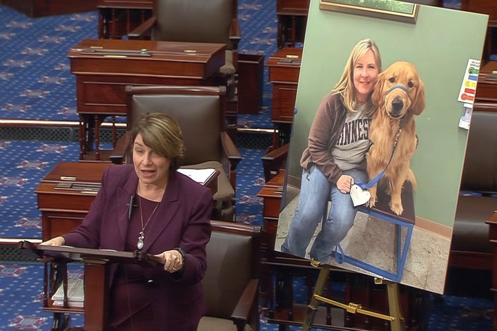 Minnesota Sen. Amy Klobuchar (D) speaks on the Senate floor in front of a photo of Minnesota state Rep. Melissa Hortman and Gilbert.