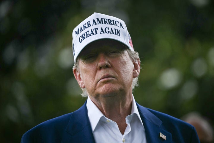 President Donald Trump speaks to the press as workers install a large flag pole on the South Lawn of the White House in Washington, DC on June 18, 2025. (Photo by BRENDAN SMIALOWSKI/AFP via Getty Images)