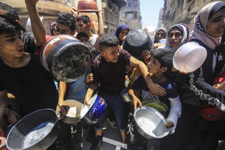 Israel Kills 140 Palestinians In 24 Hours As World Shifts Focus To Iran 1 Palestinians receive food aid as people continue to struggle with hunger as a result of ongoing Israeli attacks in Gaza City on June 18, 2025.