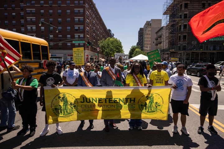 People participate in a march celebrating Juneteenth on June 15, 2024, in the Harlem neighborhood of New York.