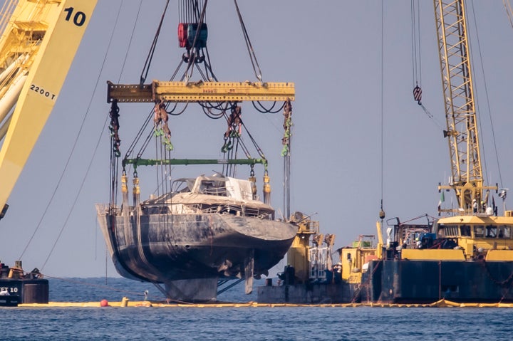 The 184-foot superyacht is seen after being hauled from the waters off Sicily on Saturday as salvage recovery crews completed the complex operation to bring it ashore for further investigation.