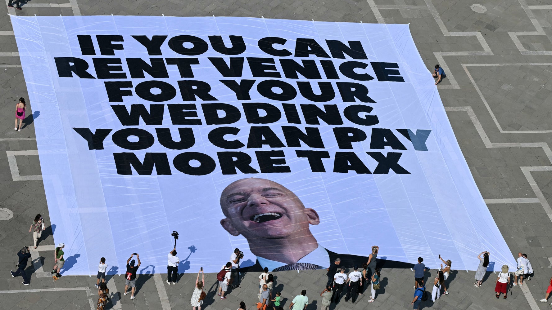 Protestors Tell Bezos To Pay More Taxes Ahead of Venice Wedding | HuffPost  Latest News