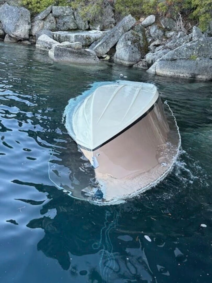 In the photo released by the U.S. Coast Guard, a capsized vessel floats is seen near D.L. Bliss State Park at Lake Tahoe, Calif., June 21, 2025.