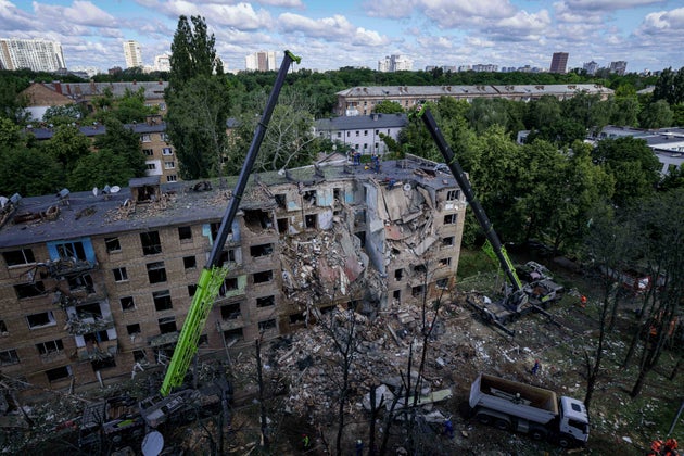 Rescue workers clear the rubble of a residential building destroyed by a Russian strike in Kyiv, Ukraine.