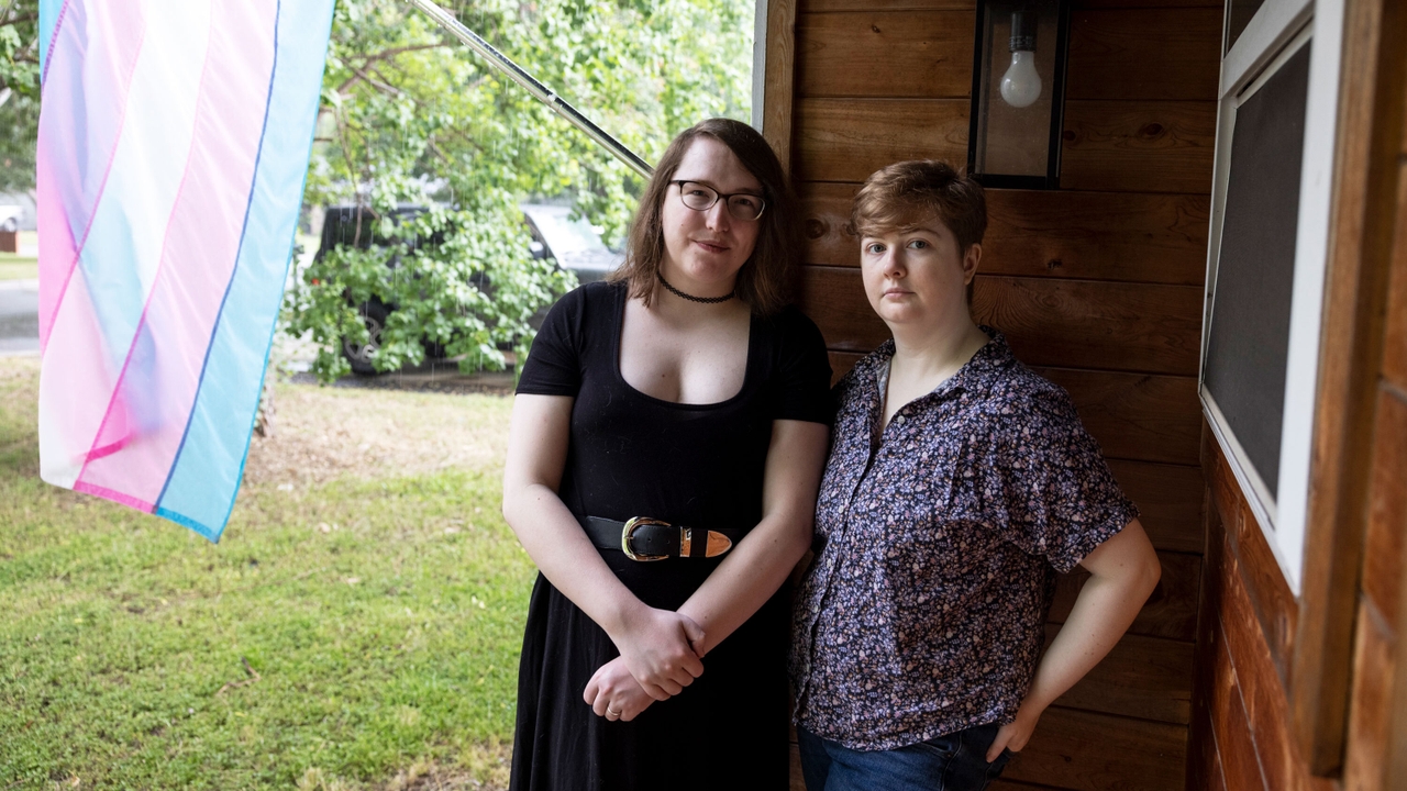 Claire and Heather Clark pose in front of their house of Austin. Since Texas approved a list of Anti-Trans laws this year, the couple has additional concerns about their rights and protections.