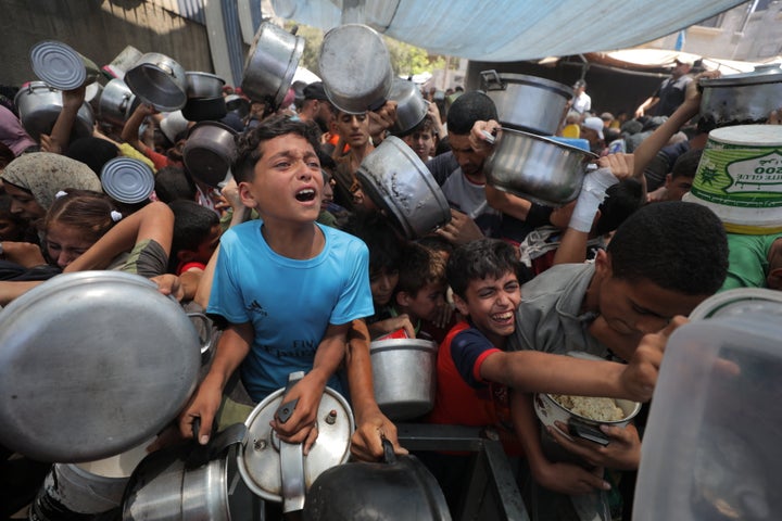 Palestinians receive food aid at the Nusierat refugee camp in Gaza City, Gaza, on June 26, 2025.