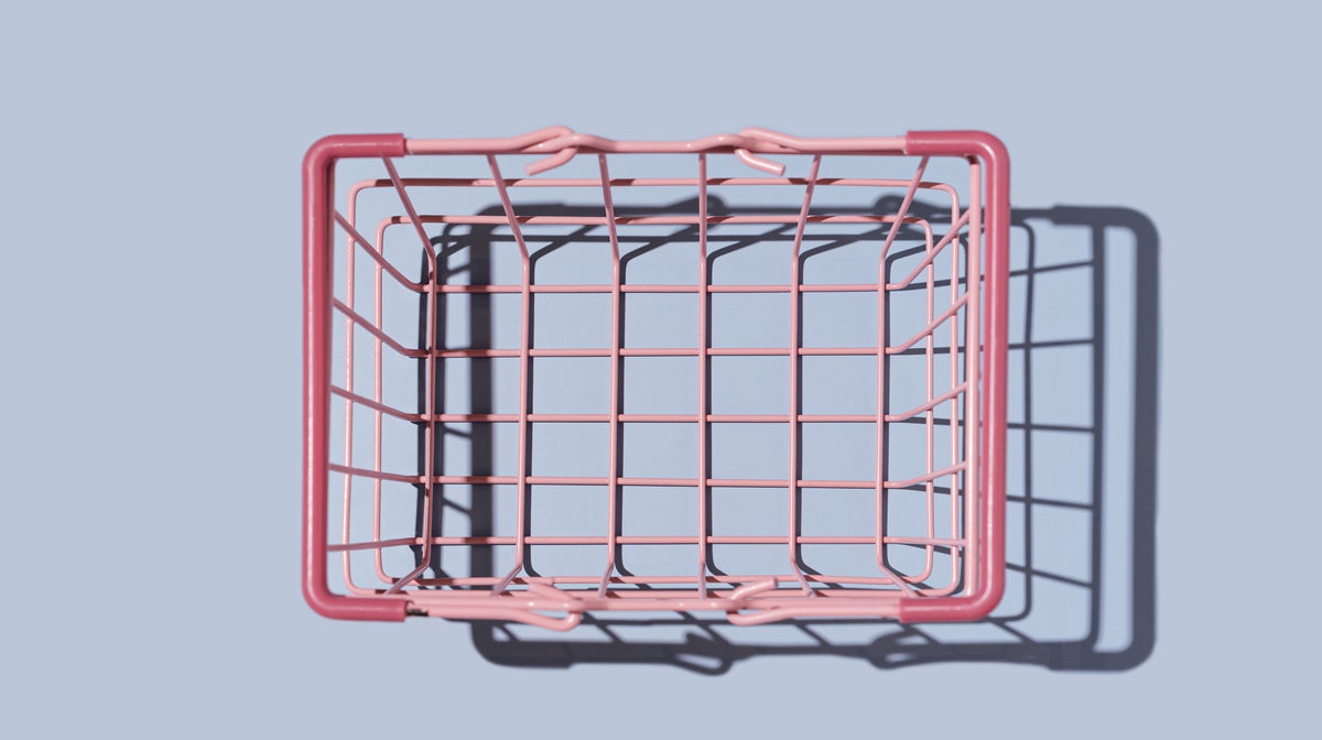 Empty shopping basket on blue background