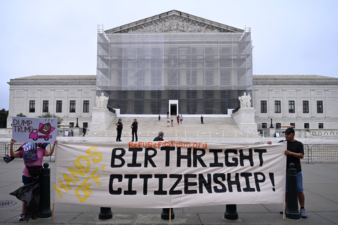 Demonstrators holds up an anti-Trump sign outside the US Supreme Court in Washington, D.C., on June 27.
