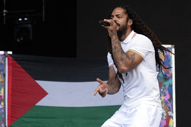 To the backdrop of a Palestinian flag, Bobby Vylan of British duo Bob Vylan performs on the West Holts Stage on the fourth day of the Glastonbury festival,