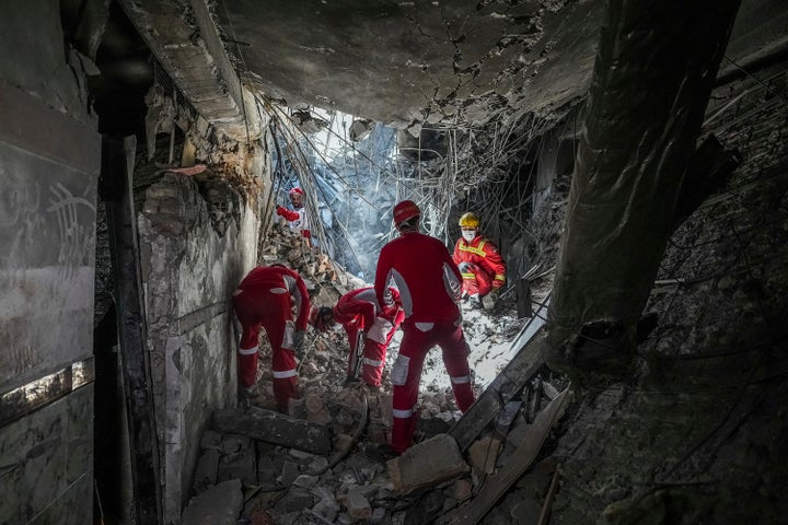 In this photo taken Tuesday, June 24, 2025, rescuers search through the rubble of a damaged section of Evin Prison following an Israeli strike the day before, in Tehran, Iran. (AP Photo/Mostafa Roudaki/Mizan News Agency)