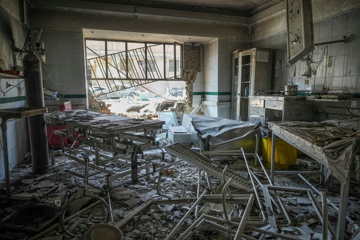 In this photo taken Tuesday, June 24, 2025, rescuers search through the rubble of a damaged section of Evin Prison following an Israeli strike the day before, in Tehran, Iran. (AP Photo/Mostafa Roudaki/Mizan News Agency)
