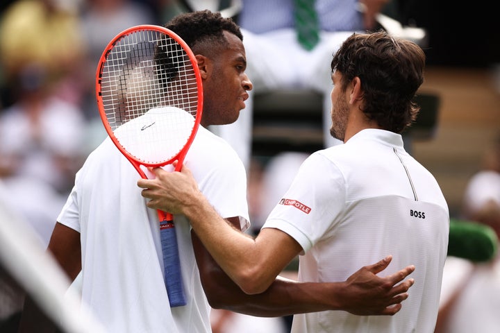Victorious Taylor Fritz of the U.S. hugs France's Giovanni Mpetshi Perricard at the end of their men's singles first round tennis match at Wimbledon. 