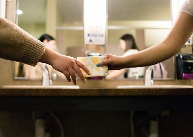 Women exchanging period pads